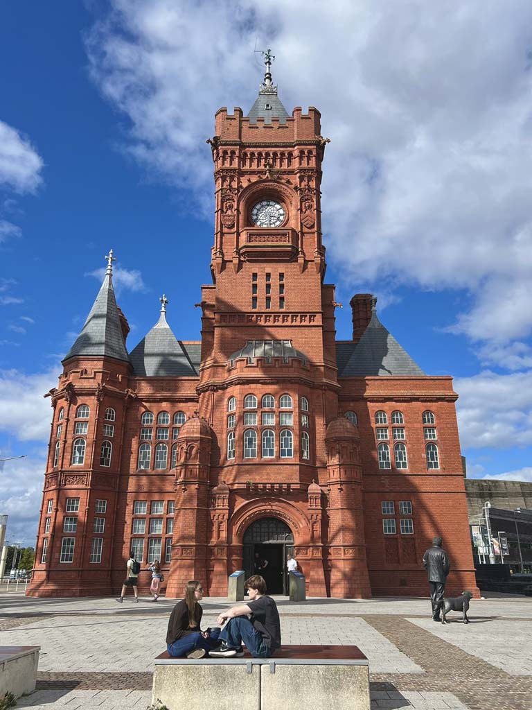 A large red building with lots of windows and a clock
