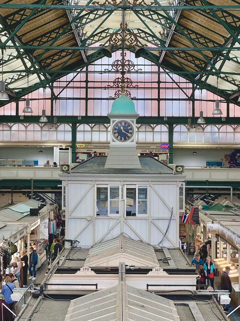 The interior of a large market, with a central clocktower
