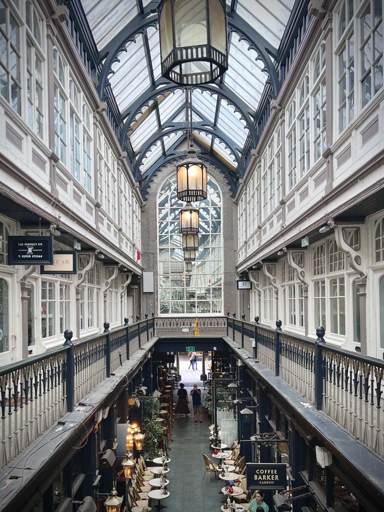 The interior of an ornate shopping arcade, seen from the balcony