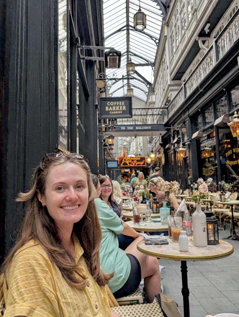 A woman sitting smiling inside an arcade