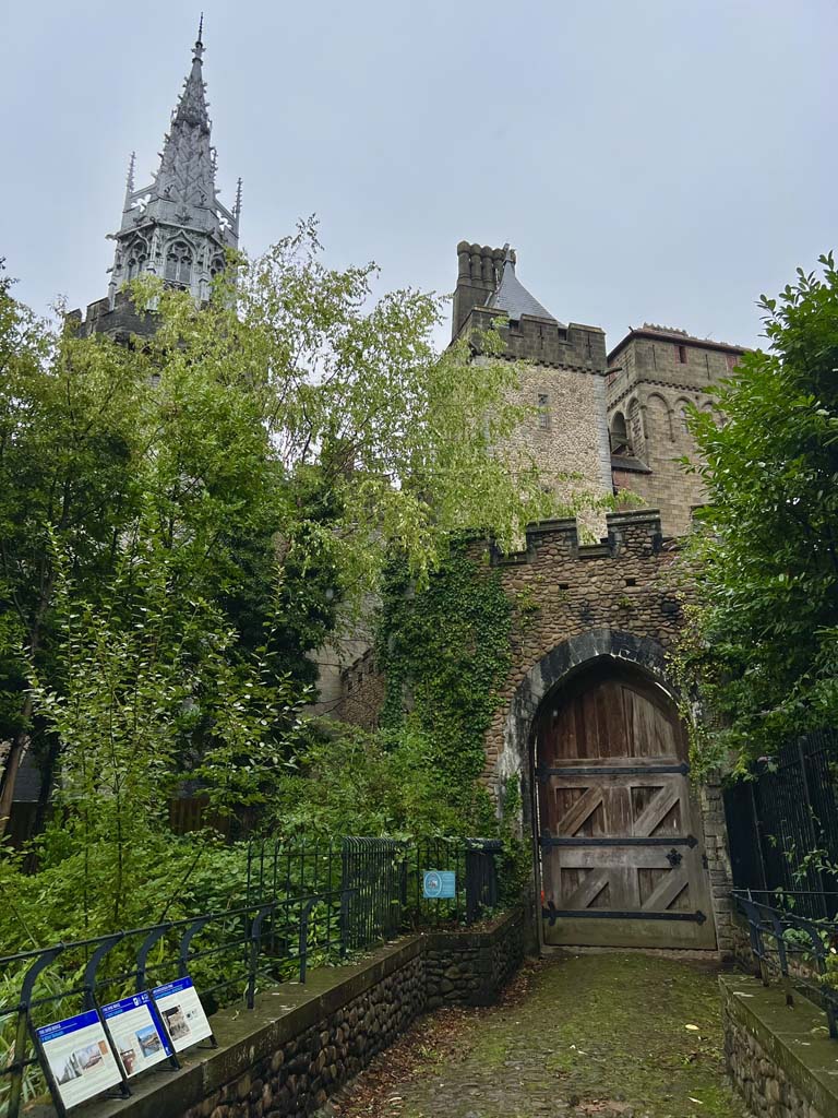 A castle gate with overgrown bushes